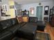 Inviting living area with a plush leather sectional sofa, hardwood floors, and eclectic decor at 1735 Tall Pine Cir, Safety Harbor, FL 34695