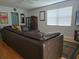 Spacious living room showcasing a large leather sofa, hardwood floors, and natural light at 1735 Tall Pine Cir, Safety Harbor, FL 34695