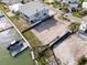 Aerial view showcasing vacant lot with dock and canal, highlighting the potential for waterfront living at 211 Bath Club N Blvd, North Redington Beach, FL 33708