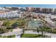 Aerial of community featuring tennis courts, playground, mature landscaping, and the Gulf Coast beaches at 211 Bath Club N Blvd, North Redington Beach, FL 33708