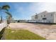 Vacant waterfront lot ready for a new home, with grass and sand at 211 Bath Club N Blvd, North Redington Beach, FL 33708