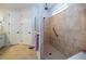 Clean bathroom featuring a tiled shower with glass partition and neutral colored floor tiles at 4748 Ballast Crest Cv, Land O Lakes, FL 34638