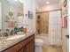 Cozy bathroom featuring a granite countertop vanity, white toilet, and tiled shower-tub combo at 4748 Ballast Crest Cv, Land O Lakes, FL 34638