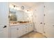 A bright primary bathroom boasts double sinks with white cabinets and a walk-in shower at 4748 Ballast Crest Cv, Land O Lakes, FL 34638