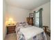 Cozy bedroom with a patchwork quilt, wood furnishings, and bright window at 4748 Ballast Crest Cv, Land O Lakes, FL 34638