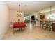 Open-concept dining room with tile flooring leading into the kitchen and living area at 4748 Ballast Crest Cv, Land O Lakes, FL 34638