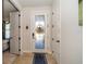 Bright foyer with decorative glass door, tile flooring, and access to the bedroom at 4748 Ballast Crest Cv, Land O Lakes, FL 34638