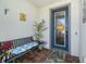 Inviting front porch featuring a bench, plants, and a decorated front door at 4748 Ballast Crest Cv, Land O Lakes, FL 34638