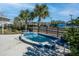 Inviting community hot tub area with blue tile, surrounded by lush landscaping and comfortable seating at 4748 Ballast Crest Cv, Land O Lakes, FL 34638