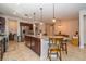 Open kitchen features a large island, stainless refrigerator, dark wood cabinets, and tile floors at 4748 Ballast Crest Cv, Land O Lakes, FL 34638