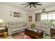 Comfortable living room featuring a plush sectional sofa and modern ceiling fan at 4748 Ballast Crest Cv, Land O Lakes, FL 34638