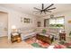 A living room with a ceiling fan, an area rug and a white sectional couch at 4748 Ballast Crest Cv, Land O Lakes, FL 34638