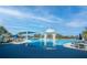 Large pool area with shade canopies, tables and chairs for relaxation in a community center at 4748 Ballast Crest Cv, Land O Lakes, FL 34638