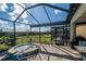 Relaxing screened-in spa area with beautiful landscaping and view of the backyard at 4748 Ballast Crest Cv, Land O Lakes, FL 34638