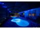 Night view of the sparkling blue pool and spa with ambient lighting at 4748 Ballast Crest Cv, Land O Lakes, FL 34638