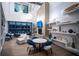 Modern sitting area with stylish furniture, sleek fireplace, and decorative shelving at 4748 Ballast Crest Cv, Land O Lakes, FL 34638