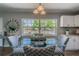 Dining room features a large window, chandelier, and glass dining table with patterned chairs at 6044 6Th N Ave, St Petersburg, FL 33710