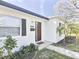 Home exterior featuring manicured landscaping and a modern front door at 6044 6Th N Ave, St Petersburg, FL 33710