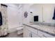Bright bathroom with granite countertops, white cabinets, and nautical-themed décor at 11721 1St E St, Treasure Island, FL 33706