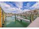 View of a boat dock surrounded by beautiful water and blue skies at 11721 1St E St, Treasure Island, FL 33706