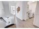 Hallway adjacent to a laundry room featuring hardwood floors and a stairway at 11721 1St E St, Treasure Island, FL 33706