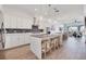 Bright kitchen boasts white cabinets, stainless appliances, and a large island with seating at 11721 1St E St, Treasure Island, FL 33706