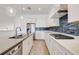 Stylish kitchen featuring white cabinets, stone countertops, and stainless steel appliances at 11721 1St E St, Treasure Island, FL 33706