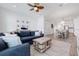 Open concept living room features coastal decor, ceiling fan, and seamless access to the dining area at 11721 1St E St, Treasure Island, FL 33706