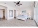 Open and airy main bedroom with white furniture, wood floors, and slider to balcony at 11721 1St E St, Treasure Island, FL 33706