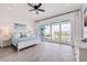 Spacious main bedroom with balcony access, white furniture and wood look floors at 11721 1St E St, Treasure Island, FL 33706