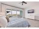Main bedroom with balcony overlooking the water, television and white dresser at 11721 1St E St, Treasure Island, FL 33706