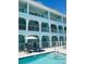 Exterior shot of a blue building featuring a swimming pool at 11721 1St E St, Treasure Island, FL 33706