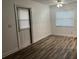 An empty bedroom with white walls and vinyl plank flooring at 401 Dorchester Pl # 62, Sun City Center, FL 33573