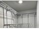 Walk-in closet with an organization system featuring chrome bars and white supports at 401 Dorchester Pl # 62, Sun City Center, FL 33573