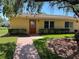 Charming single-story home with well-maintained landscaping and a welcoming walkway to the front door at 401 Dorchester Pl # 62, Sun City Center, FL 33573
