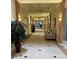 Inviting hallway with decorative lighting, tiled floor, and elegant decor at 401 Dorchester Pl # 62, Sun City Center, FL 33573