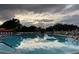 Outdoor swimming pool with relaxing seats at 401 Dorchester Pl # 62, Sun City Center, FL 33573