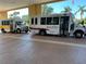 A pair of shuttle buses with the Kings Point logo parked and ready to transport residents at 401 Dorchester Pl # 62, Sun City Center, FL 33573