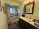 Updated bathroom featuring a modern vanity, stylish mirror, and tiled walk-in shower at 5730 16Th Ne Ln, St Petersburg, FL 33703