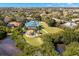Aerial view of gorgeous home, oversized yard, outdoor bar, and water views at 6785 Burning Tree Dr, Seminole, FL 33777