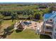 Aerial view of backyard featuring pool with spa, tiki bar, fire pit, and lush landscaping at 6785 Burning Tree Dr, Seminole, FL 33777