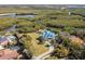 Aerial view of estate home with riverfront views and beautifully landscaped grounds at 6785 Burning Tree Dr, Seminole, FL 33777