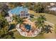 Aerial view showcasing the expansive backyard with a luxurious pool and surrounding landscaping at 6785 Burning Tree Dr, Seminole, FL 33777