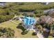 Aerial view of beautiful home with resort style pool, spa, and luxurious grounds at 6785 Burning Tree Dr, Seminole, FL 33777