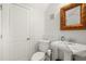 Well-lit half bathroom with pedestal sink, perfect for guests at 6785 Burning Tree Dr, Seminole, FL 33777