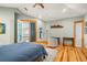 Inviting bedroom featuring hardwood floors, a comfortable bed, and a private balcony at 6785 Burning Tree Dr, Seminole, FL 33777