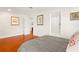 Bedroom with hardwood floors and neutral walls, offering a serene atmosphere at 6785 Burning Tree Dr, Seminole, FL 33777