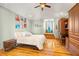 Cozy bedroom with hardwood floors, built-in desk, and ample storage at 6785 Burning Tree Dr, Seminole, FL 33777