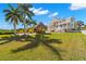 Sprawling estate with lush landscaping, tiki bar, and luxurious outdoor living spaces at 6785 Burning Tree Dr, Seminole, FL 33777