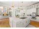 Island kitchen featuring stainless appliances, hardwood floors and open to living room at 6785 Burning Tree Dr, Seminole, FL 33777